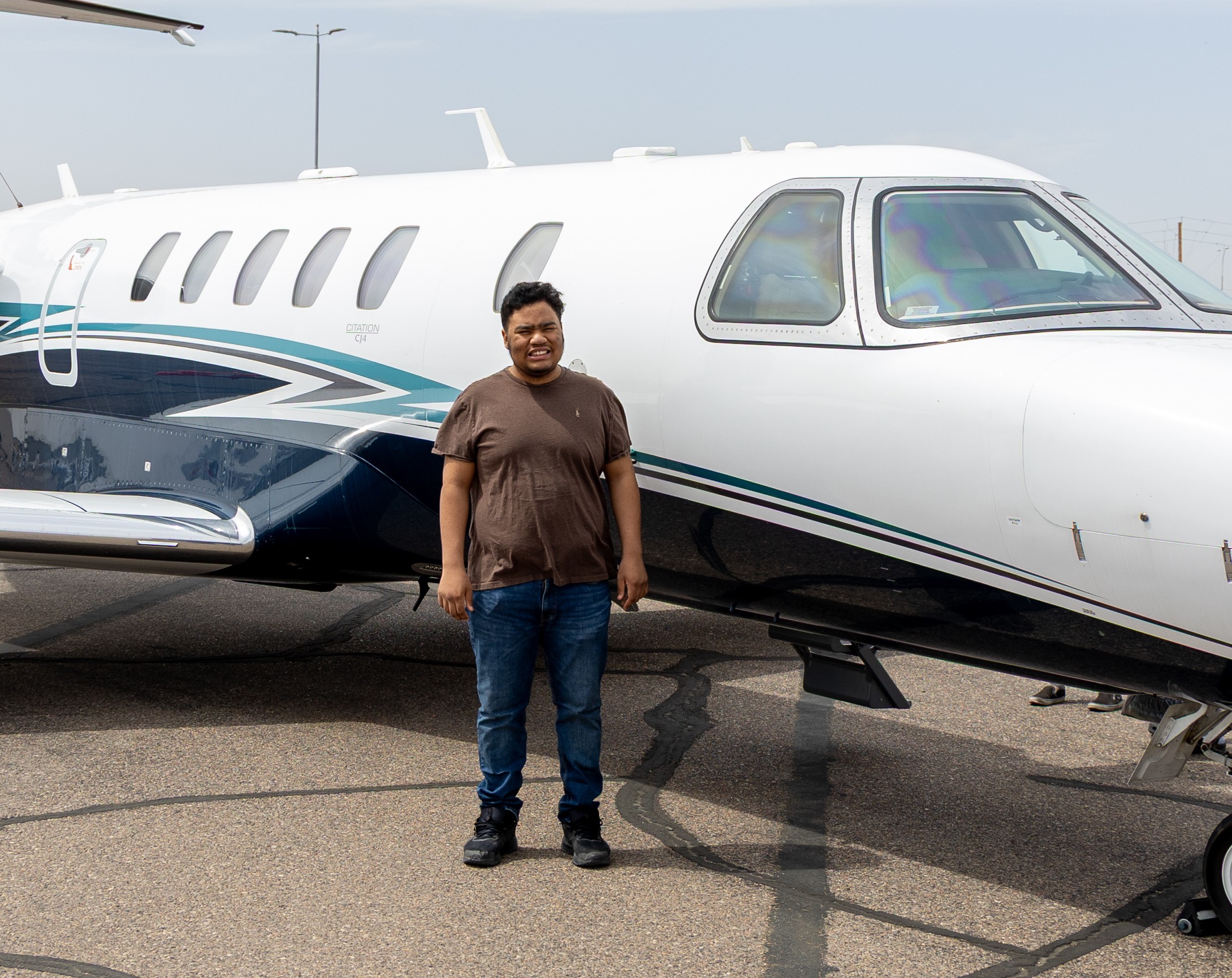 Andre standing next to plane