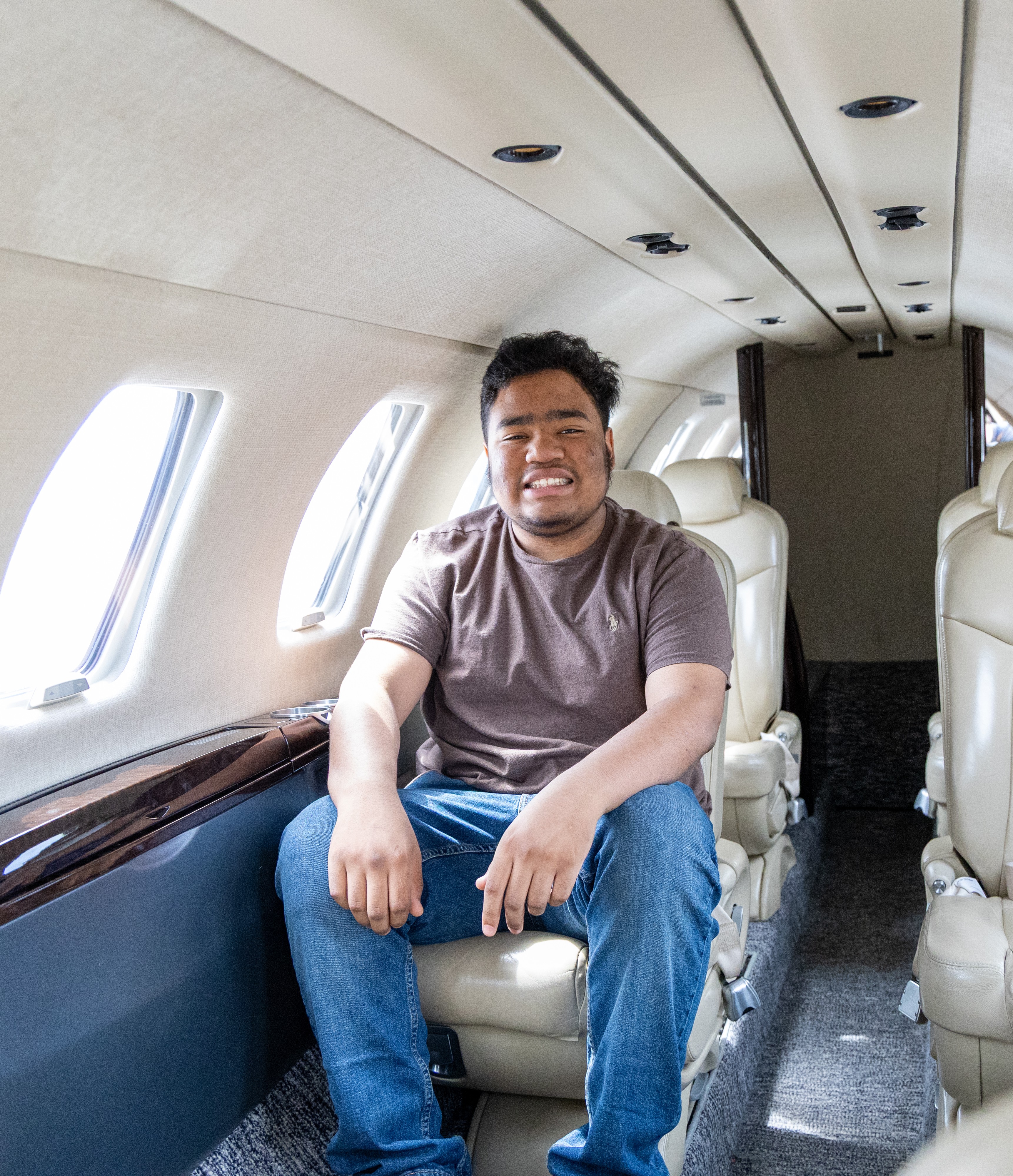Andre sitting inside of jet smiling