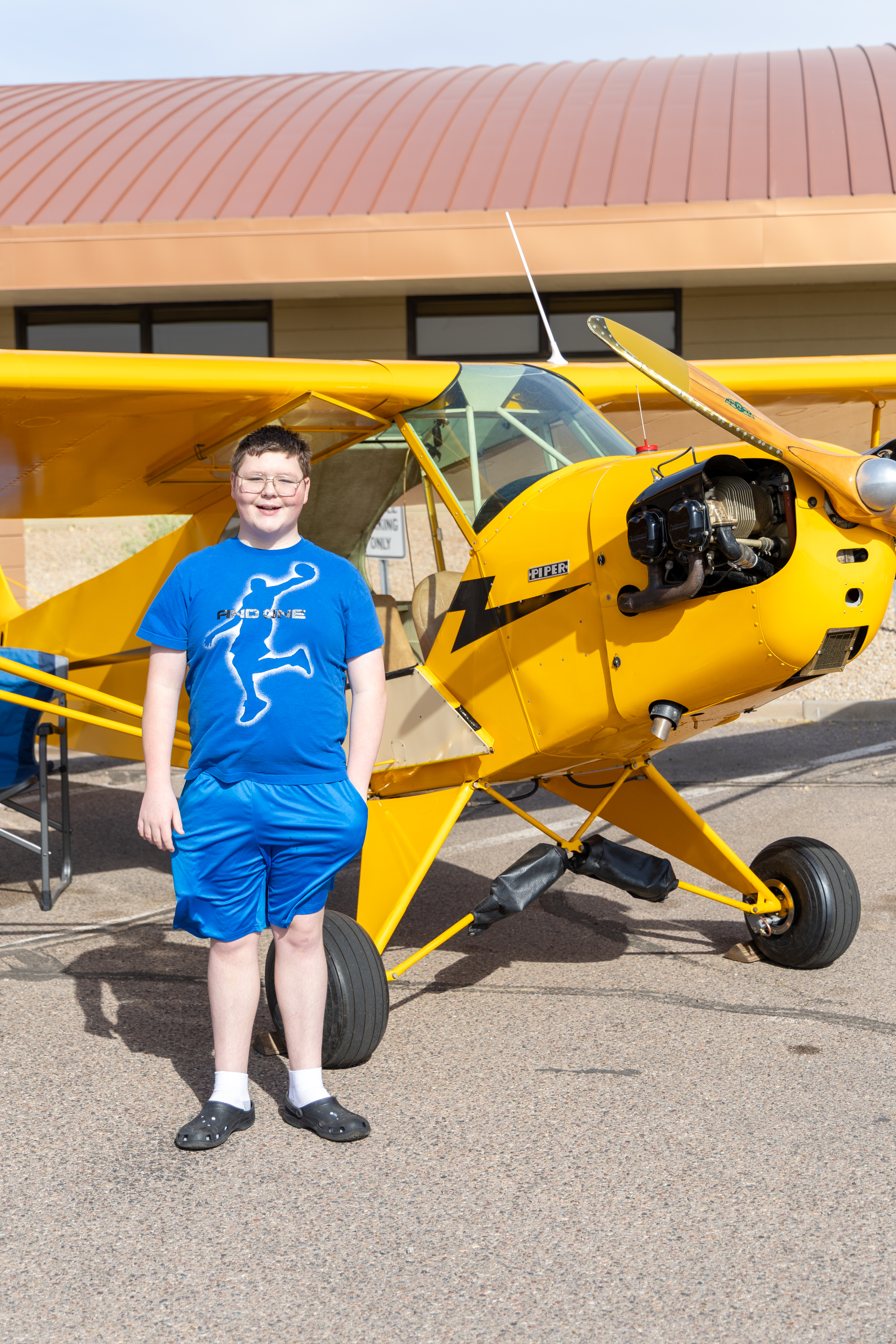 Bentley standing by plane smiling