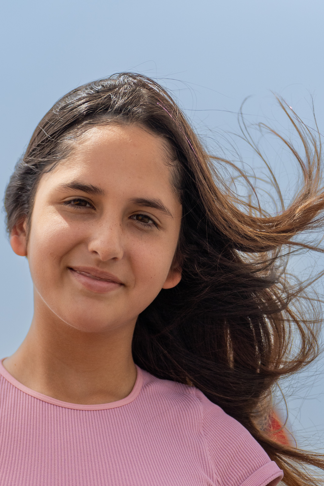 Cecilia headshot hair blowing in the wind