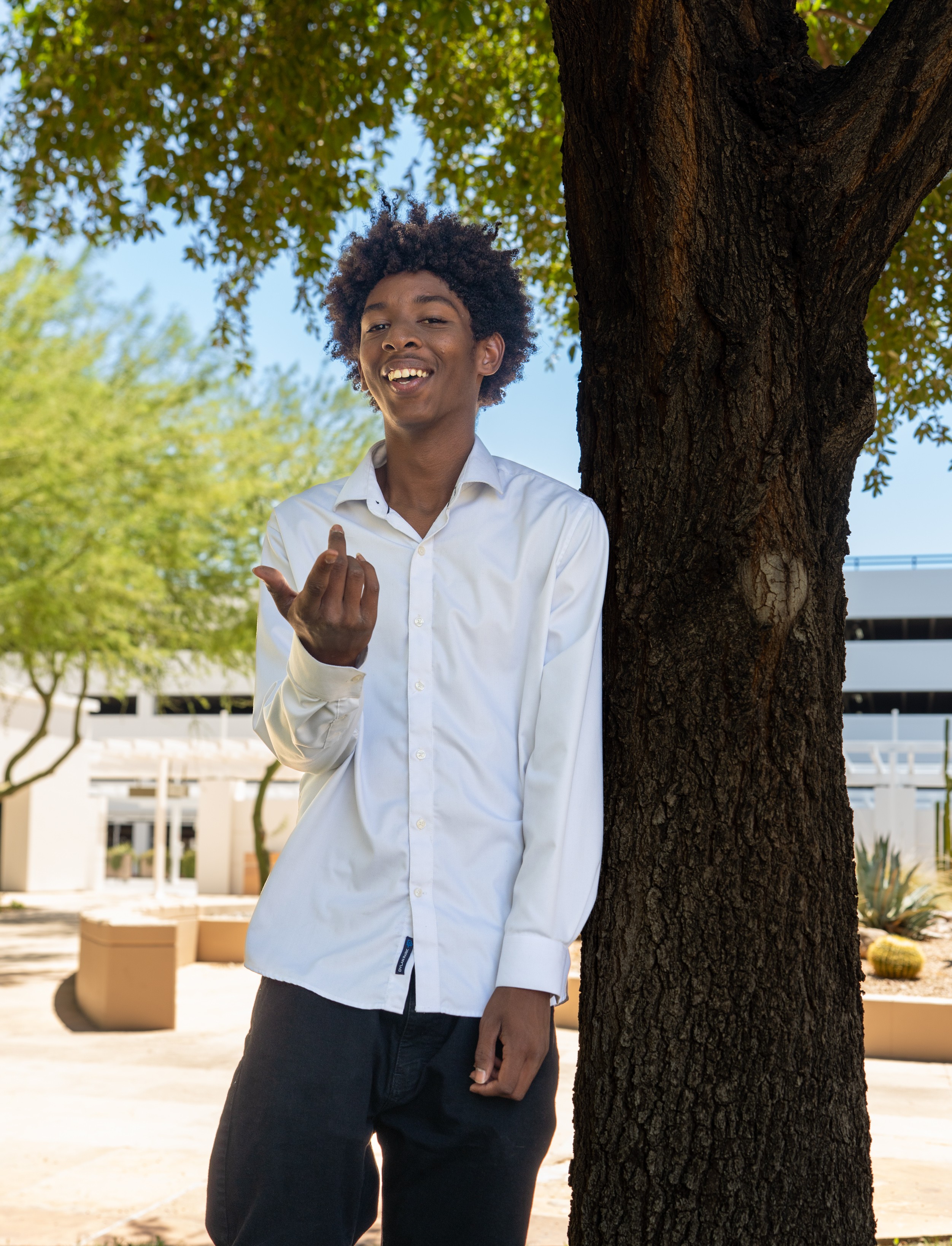 Isaiah leaning against a tree