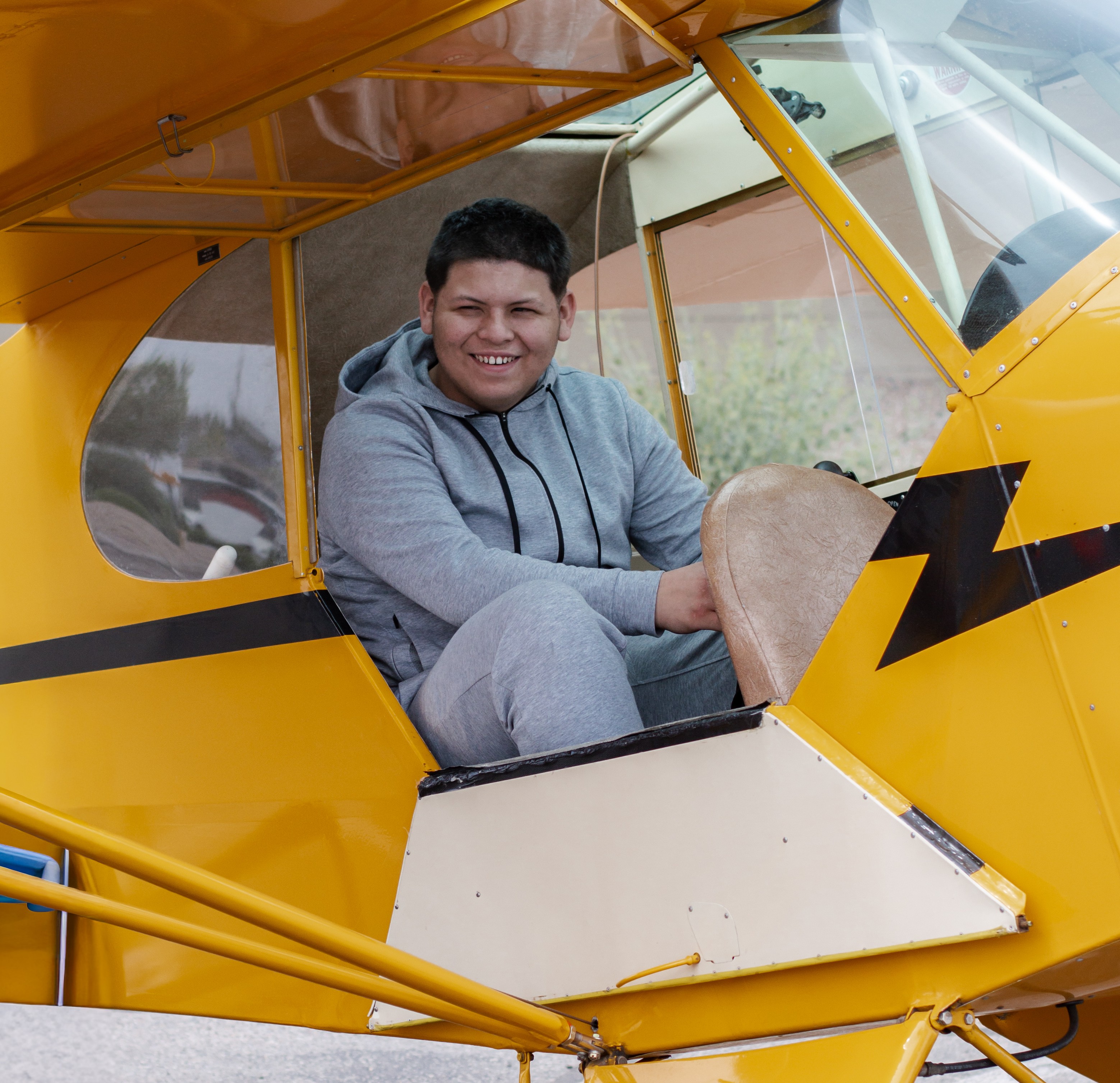 Joshua (2) sitting in yellow plane