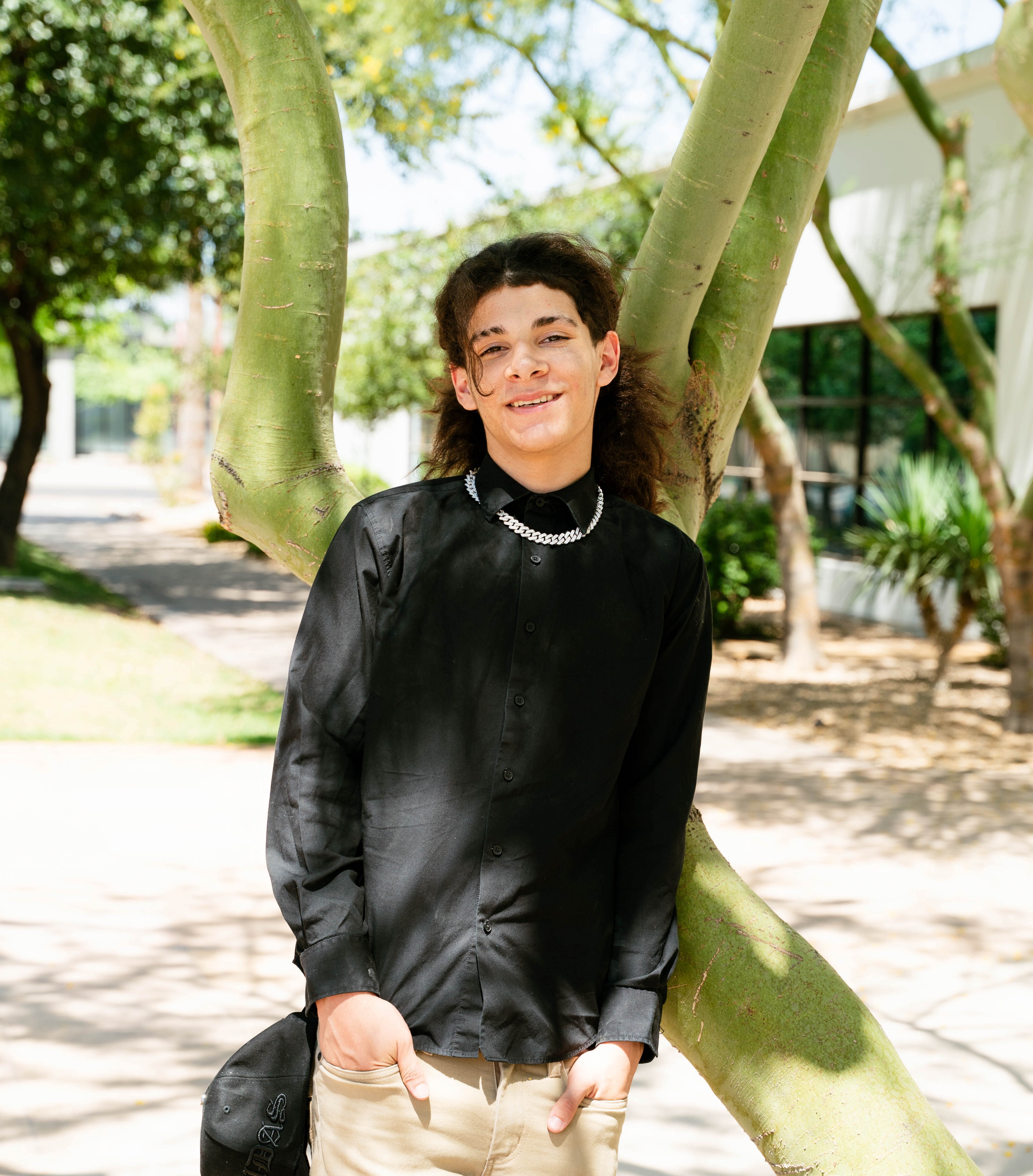 Logan (2) leaning on tree