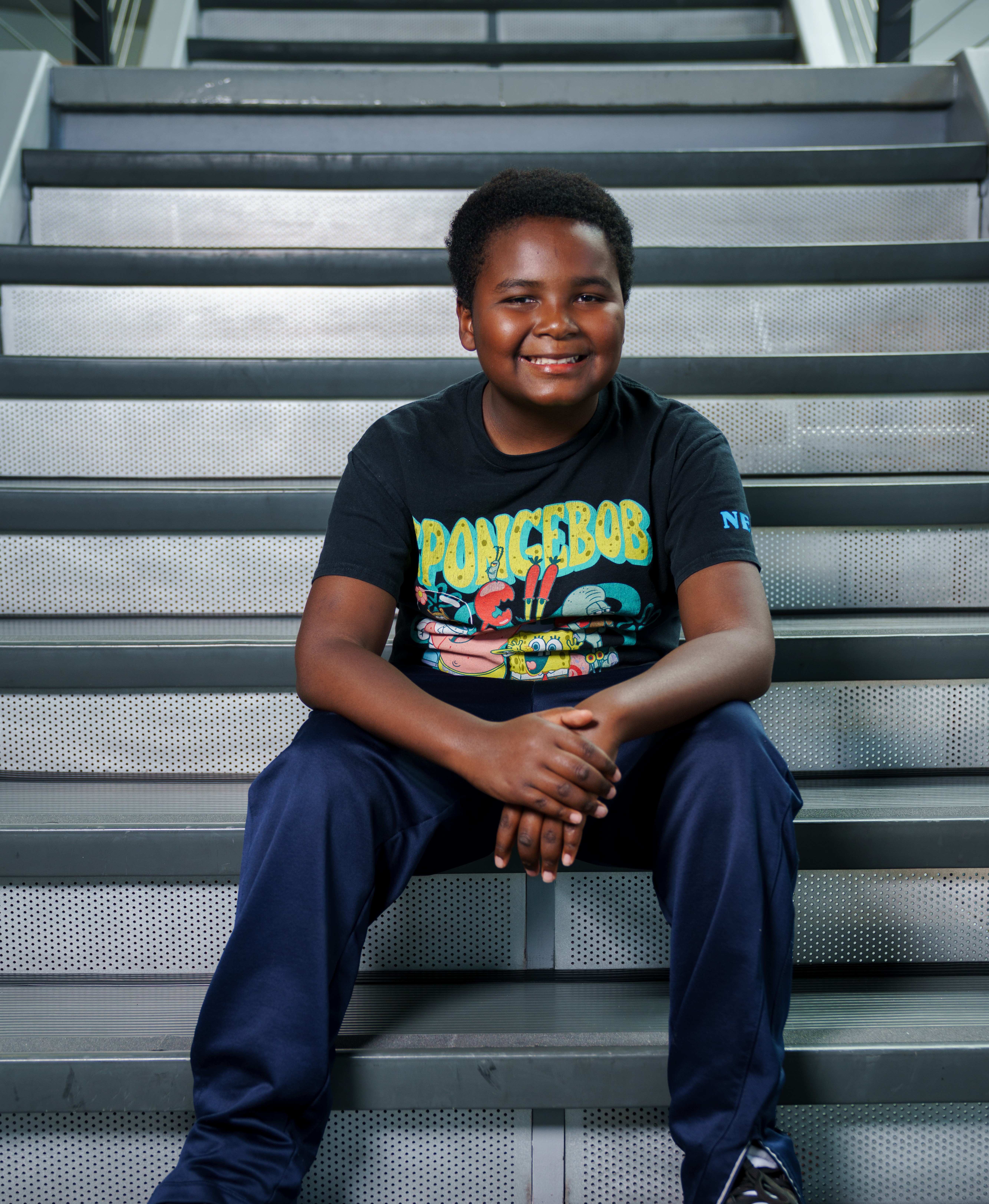 Latrell sitting on stairs