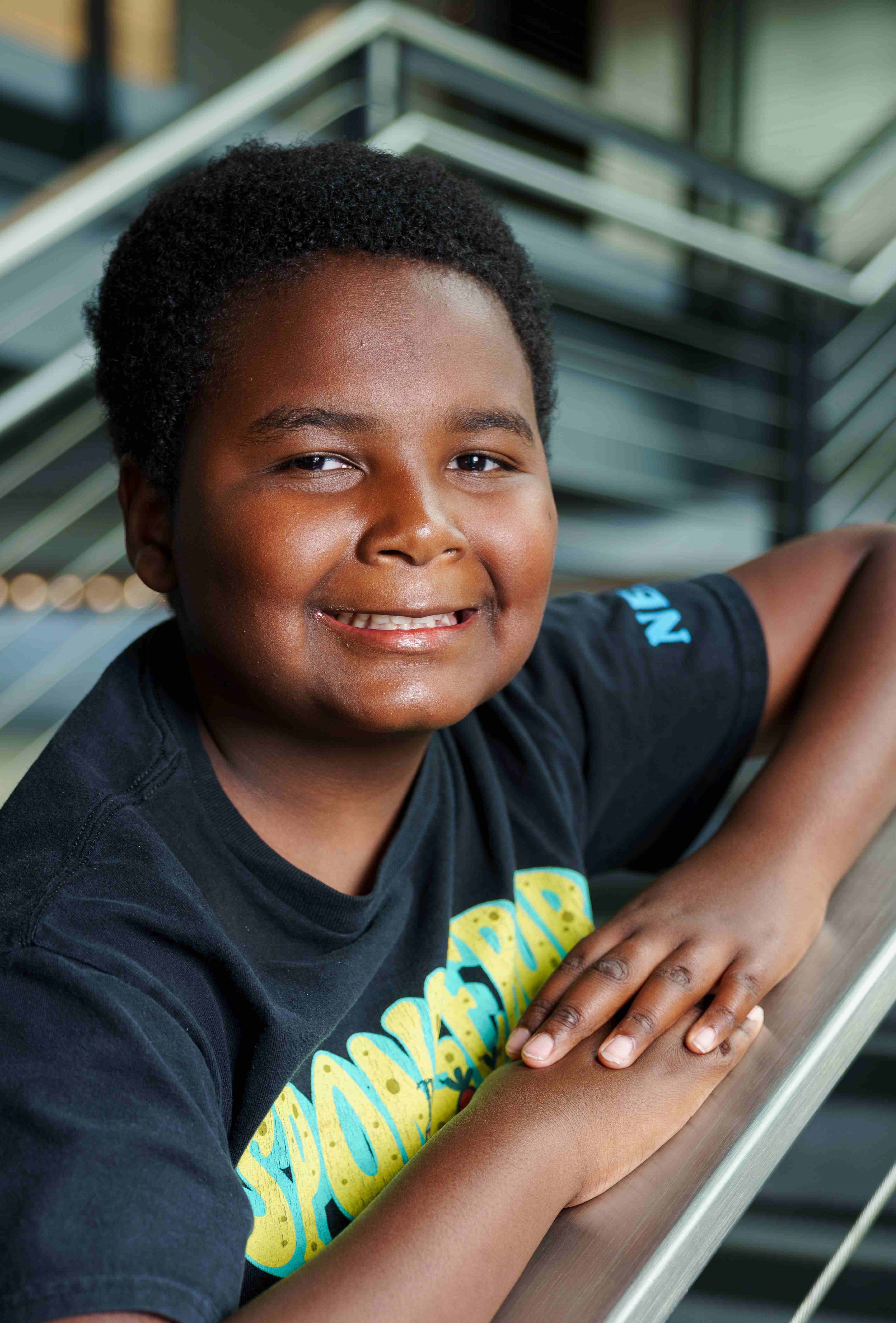 Latrell leaning on stair rail