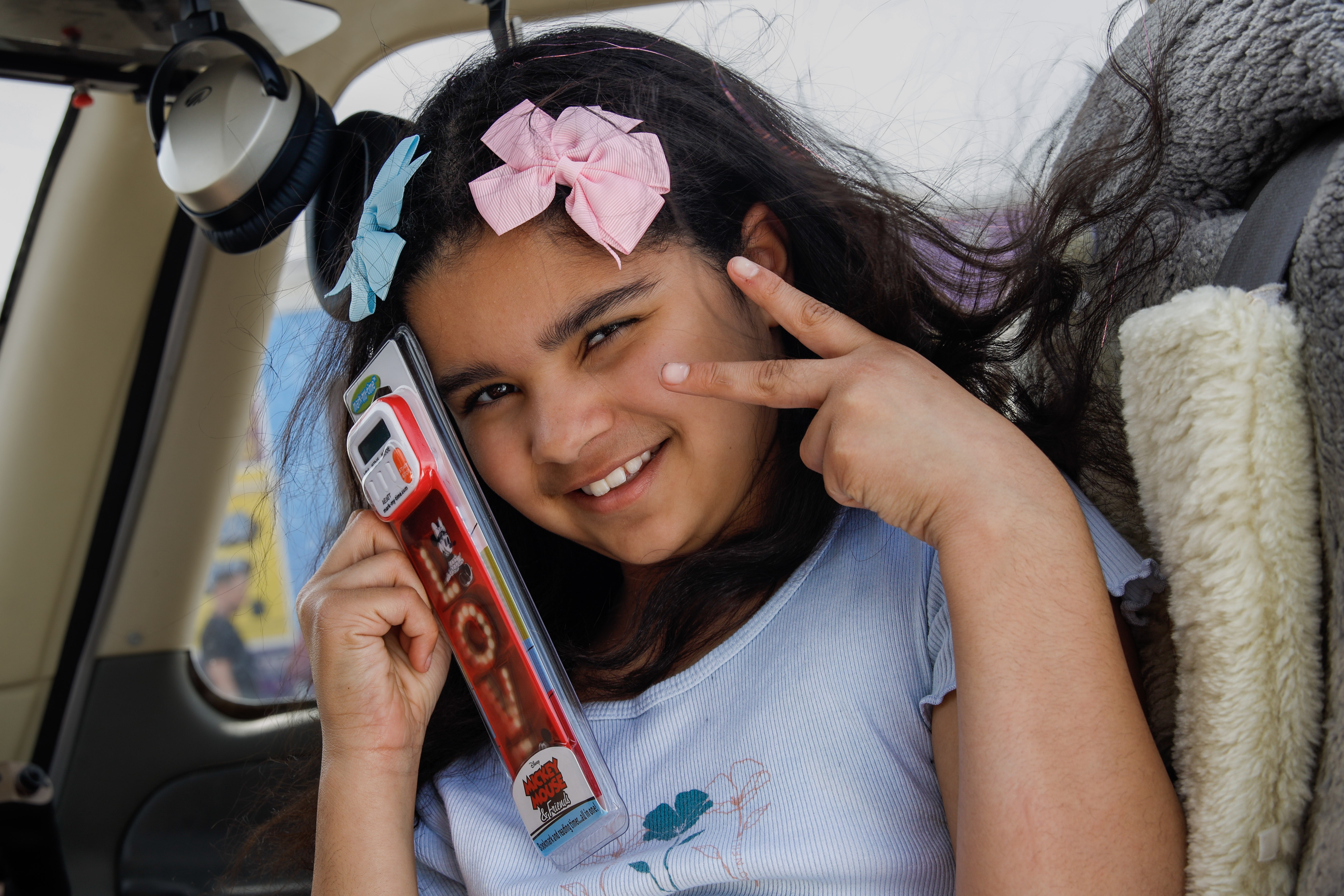 Adaleya smiling with book mark to face