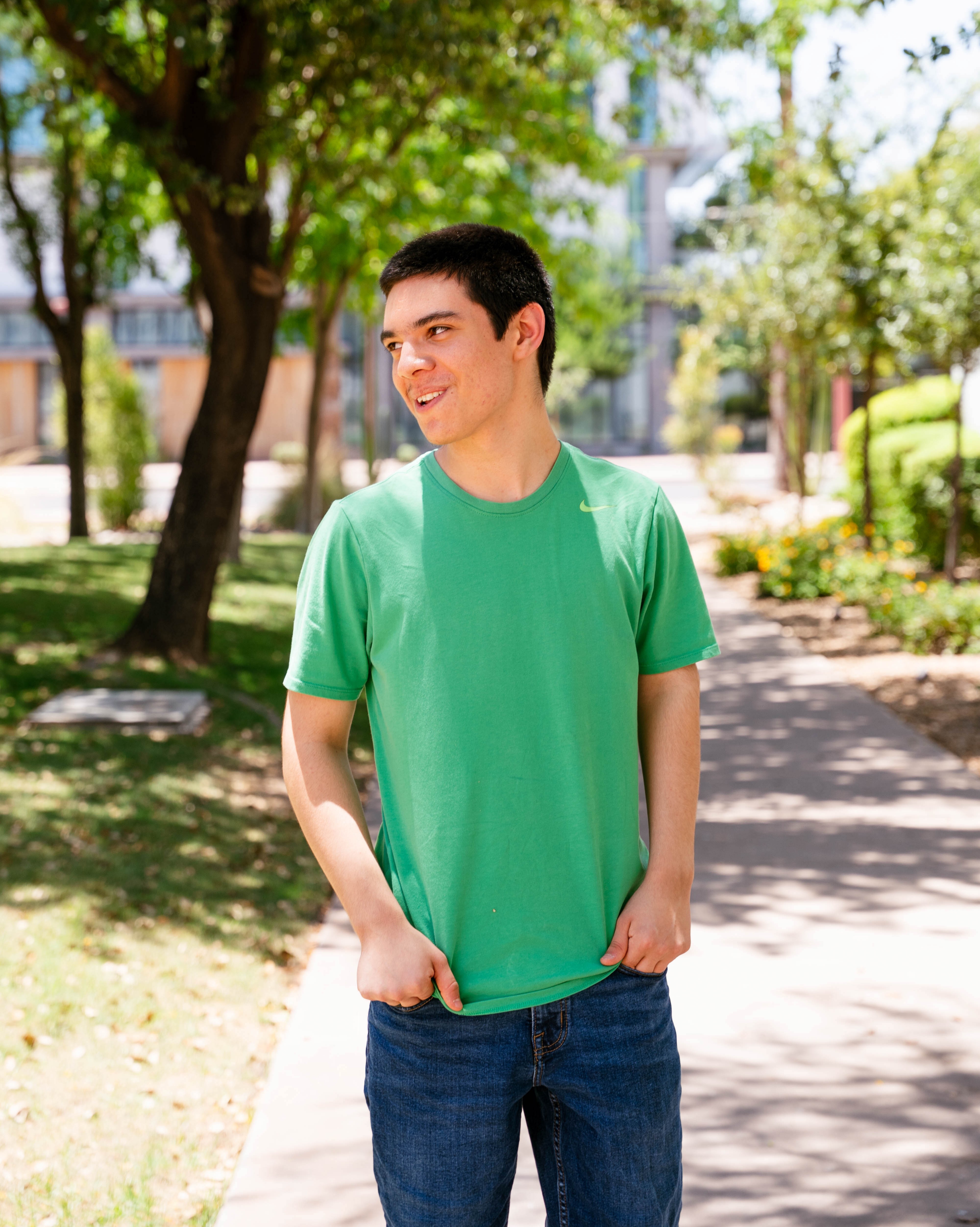Caleb standing with trees in background turned to the side