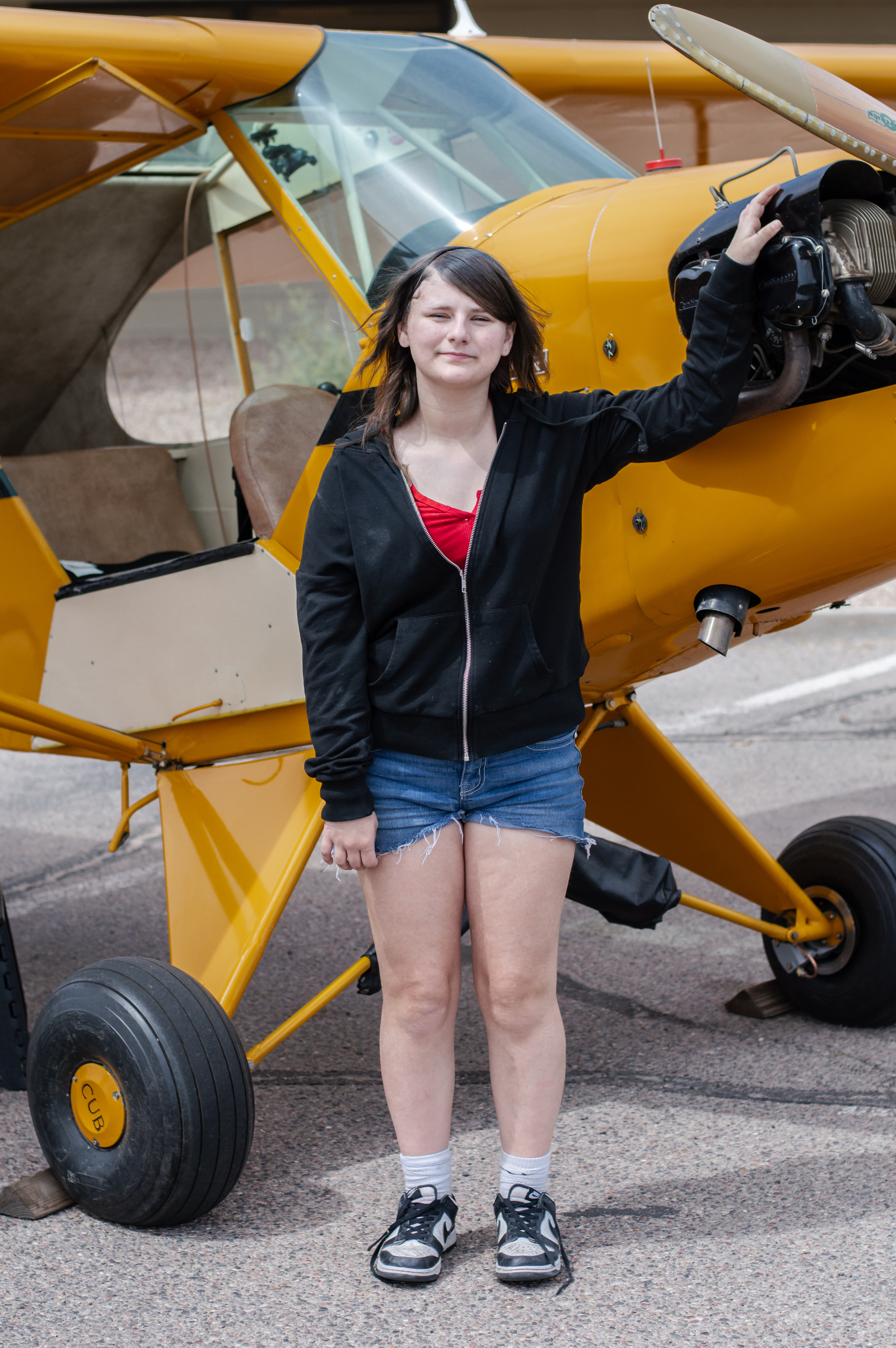 Kaylyn standing next to plane