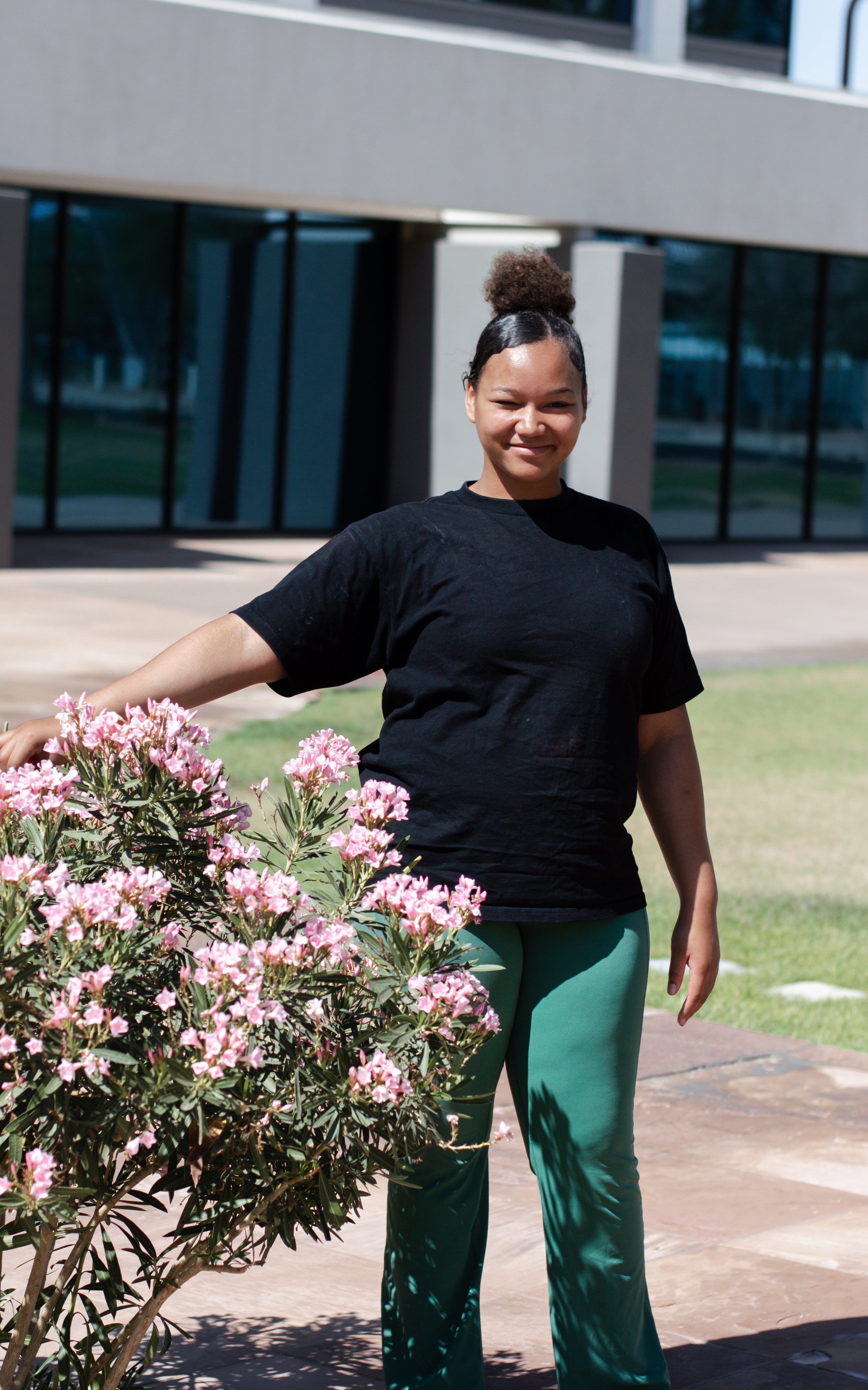 Mersaides standing next to bush with flowers