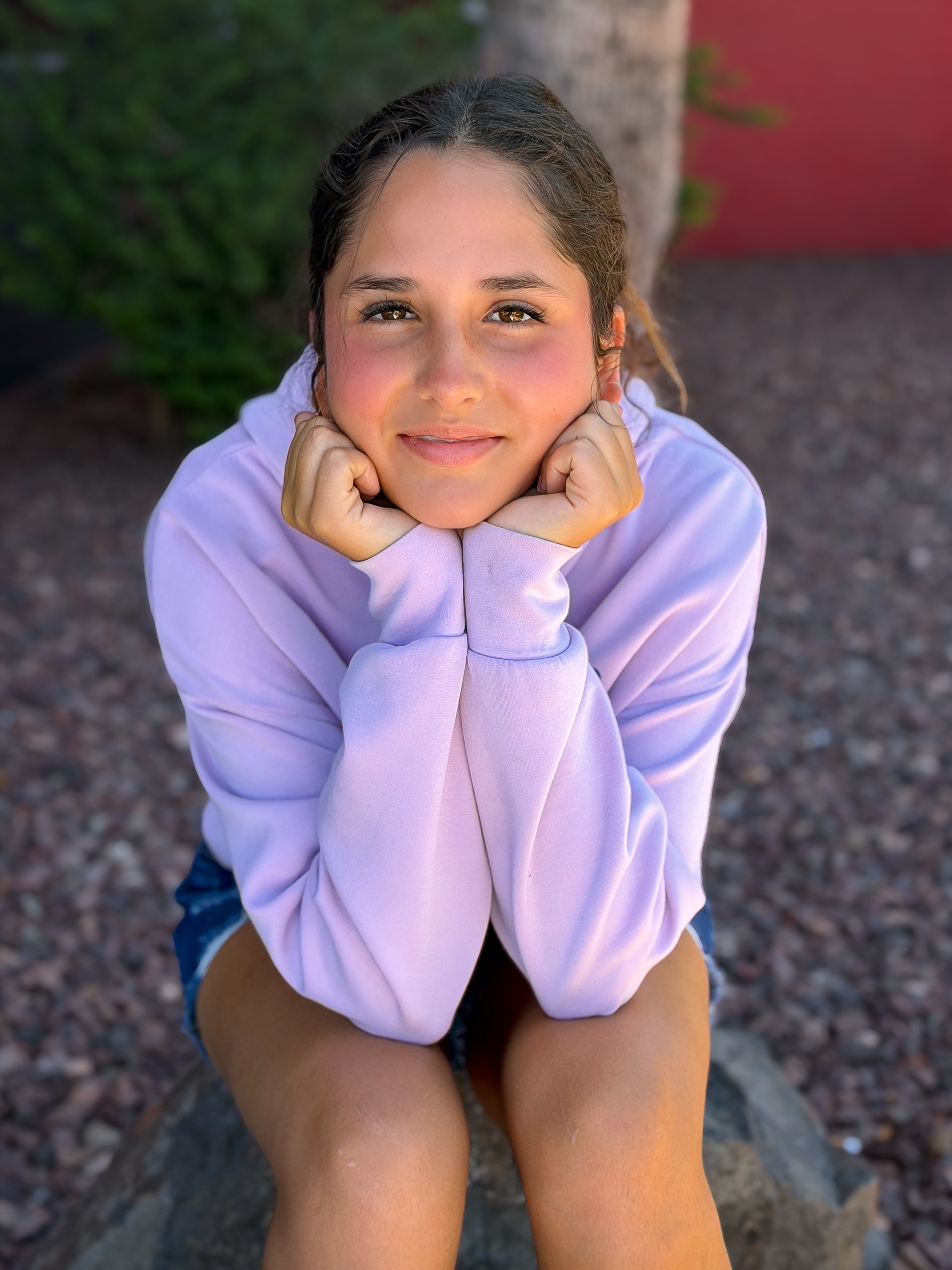 Cecilia sitting with elbows on knees and hands on face