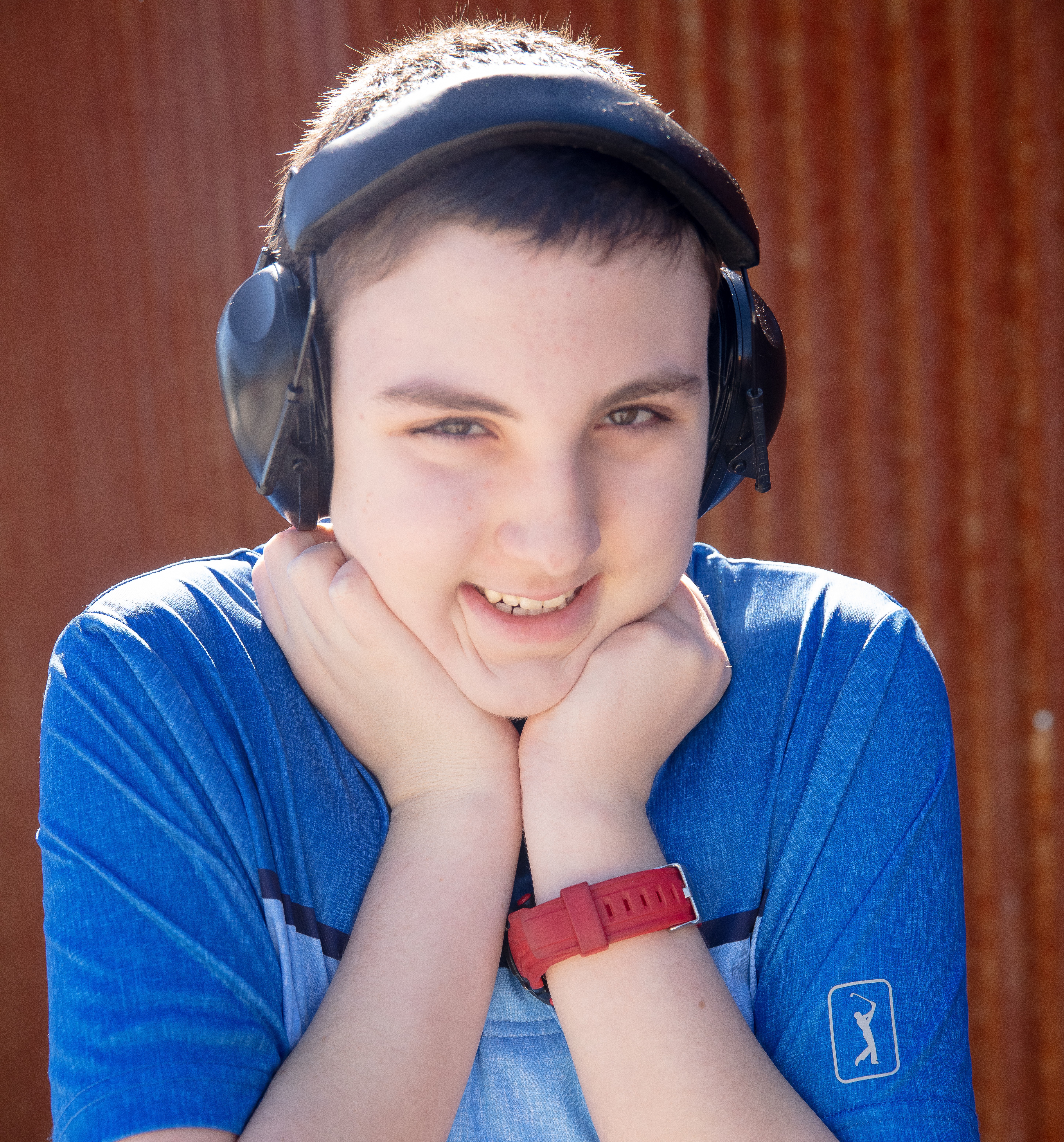 Gage smiling with his fists to his chin