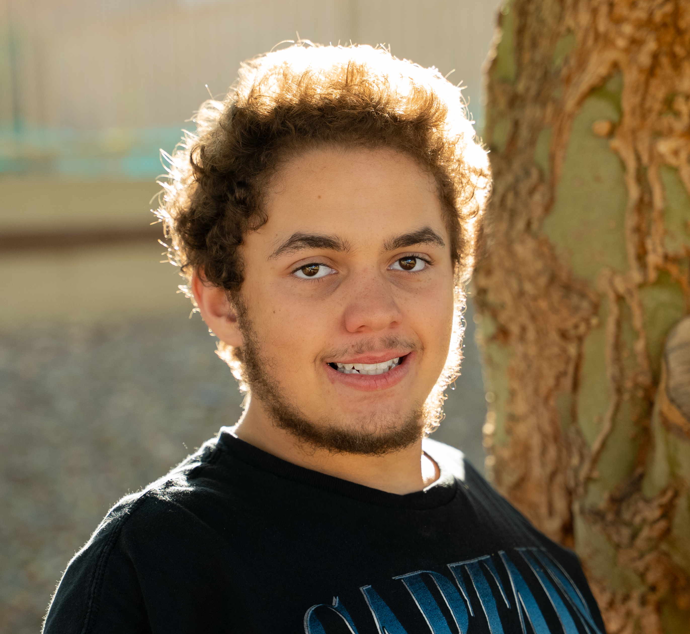 Jamarcus standing by tree