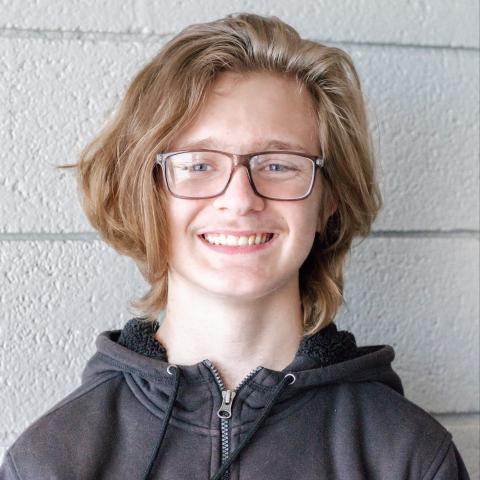 Aiden smiling with white background