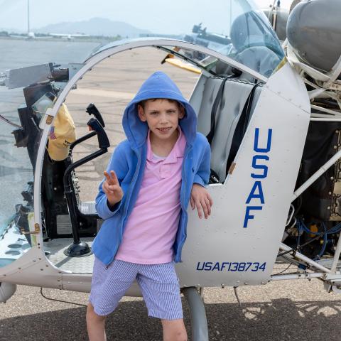 Tauke standing next to helicopter
