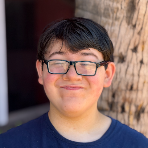 elijah smiling in front of tree