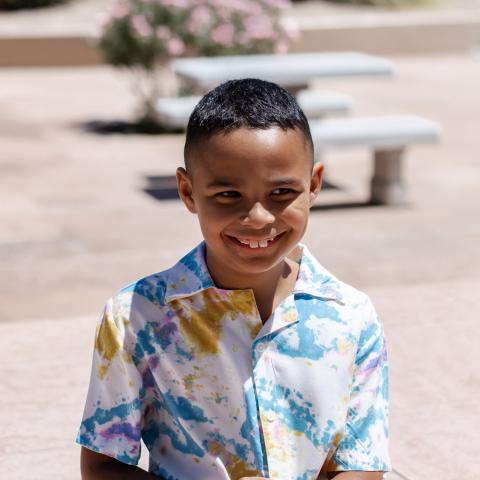 Matthew smiling with bench in background