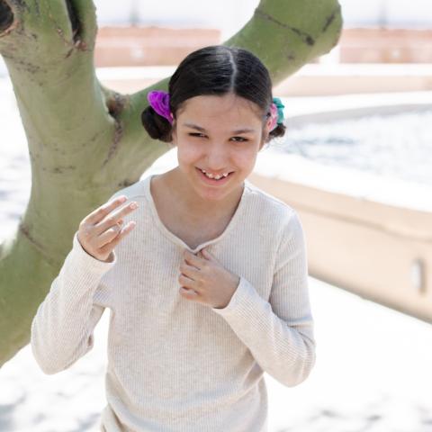 Miranda next to tree