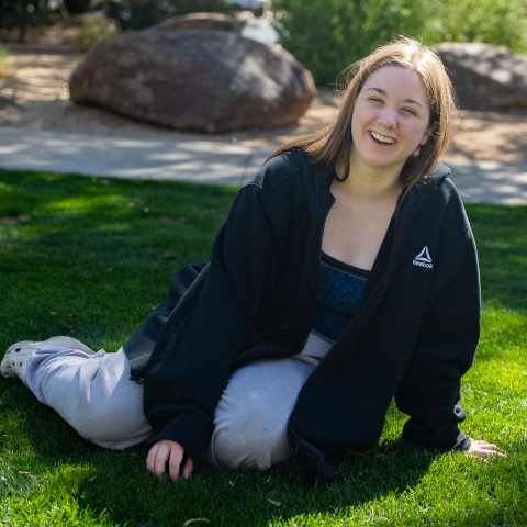 Sara sitting in grass